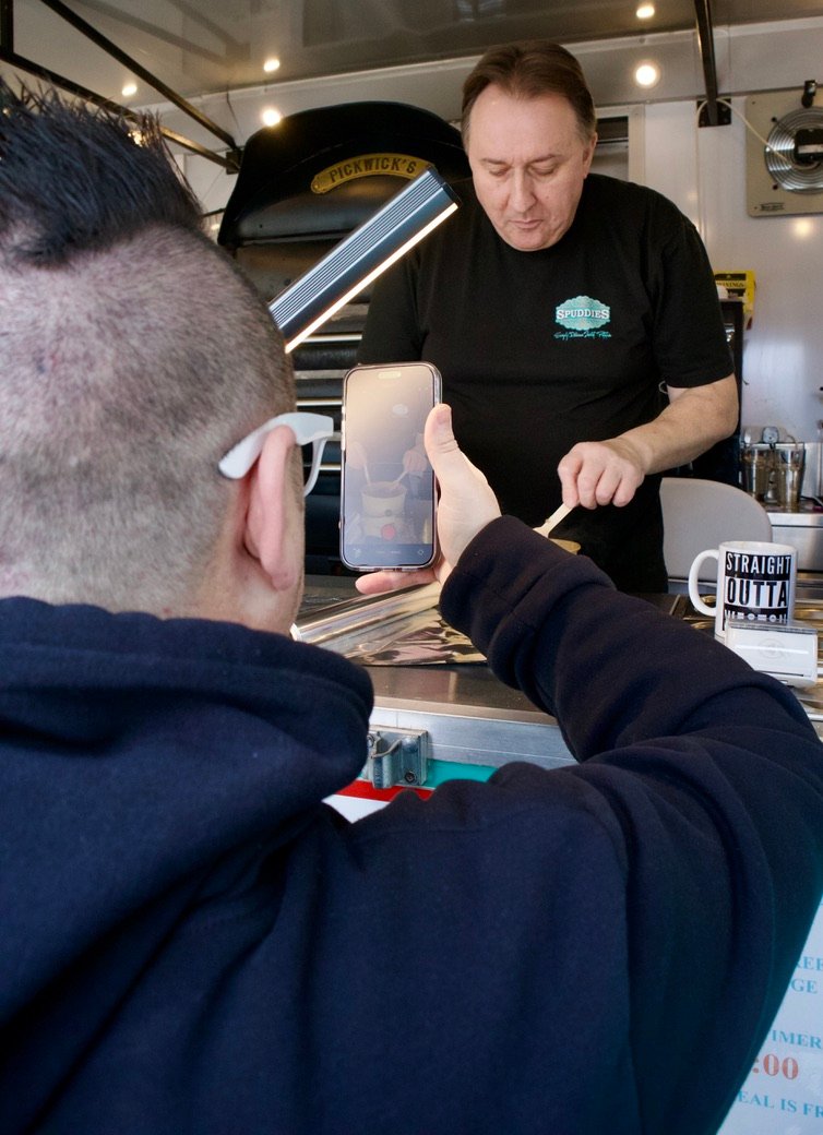 White Shades Media filming a local food vendor inside a catering trailer for social media content