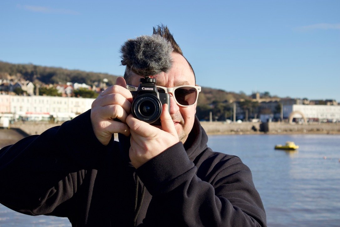 White Shades Media creator shooting with a Canon camera on the Weston-super-Mare seafront