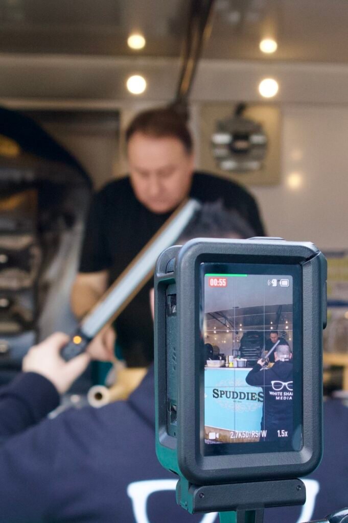 Action camera screen showing White Shades Media recording a food trailer service counter
